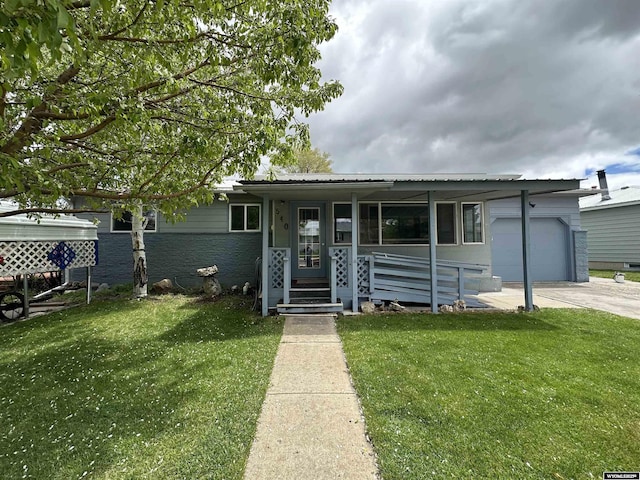 540 Smith, Lander, WY 82520 - ranch-style house with a front yard, an attached garage, a porch, and driveway