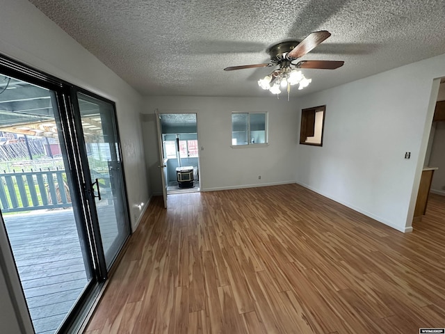 540 Smith, Lander, WY 82520 - unfurnished living room featuring wood finished floors, ceiling fan, a textured ceiling, and baseboards