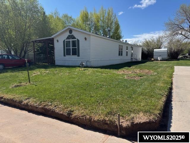 170 Eardley Ave, Fort Bridger, WY 82933 - view of home's exterior featuring a yard