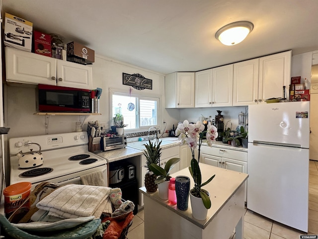 308 W Monroe St, Riverton, WY 82501 - kitchen featuring white appliances, white cabinets, light tile patterned floors, and light countertops