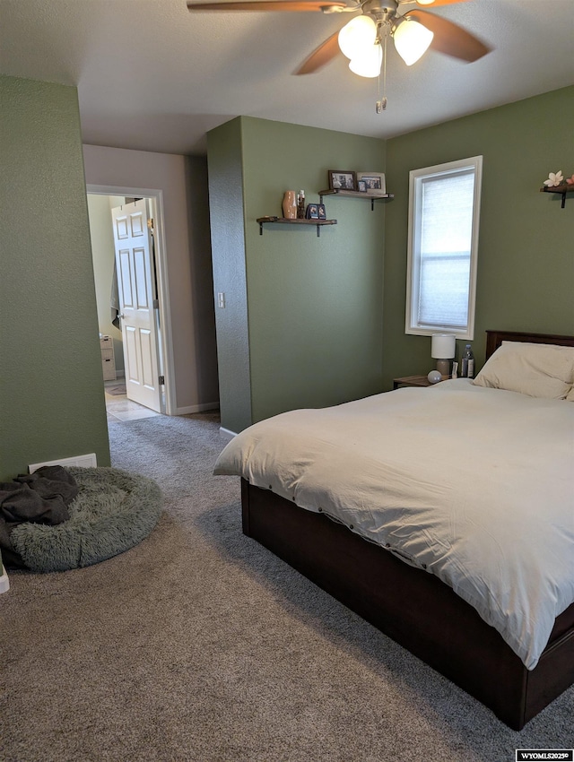 1206 E Park Ave, Riverton, WY 82501 - carpeted bedroom featuring connected bathroom, ceiling fan, and baseboards