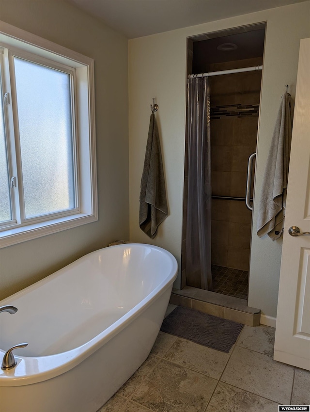 1206 E Park Ave, Riverton, WY 82501 - full bathroom featuring a freestanding tub, a shower stall, and baseboards
