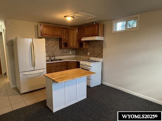 221 Fir St, Buffalo, WY 82834 - kitchen with white appliances, wood counters, decorative backsplash, and under cabinet range hood