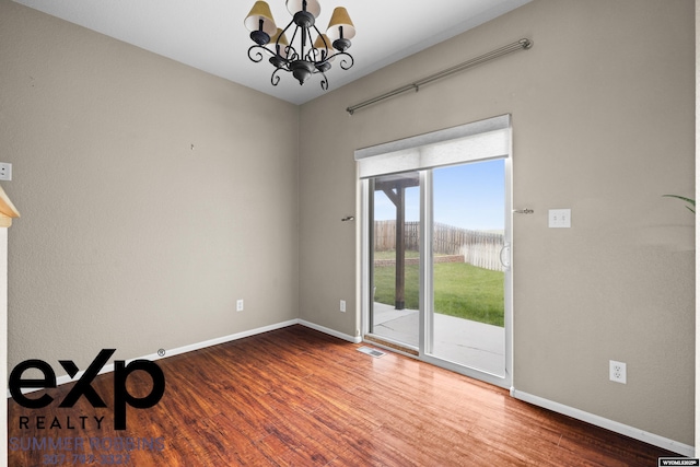 2521 Sagewood Ave, Casper, WY 82601 - unfurnished room with a chandelier, wood finished floors, and baseboards