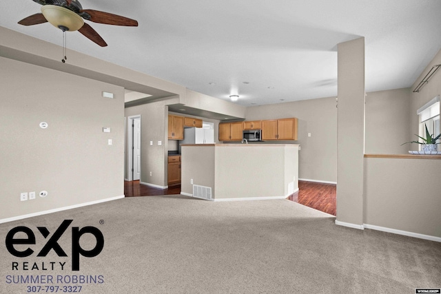 2521 Sagewood Ave, Casper, WY 82601 - unfurnished living room with dark carpet, a ceiling fan, and baseboards