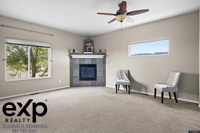 2521 Sagewood Ave, Casper, WY 82601 - carpeted living area with a tile fireplace, ceiling fan, and baseboards