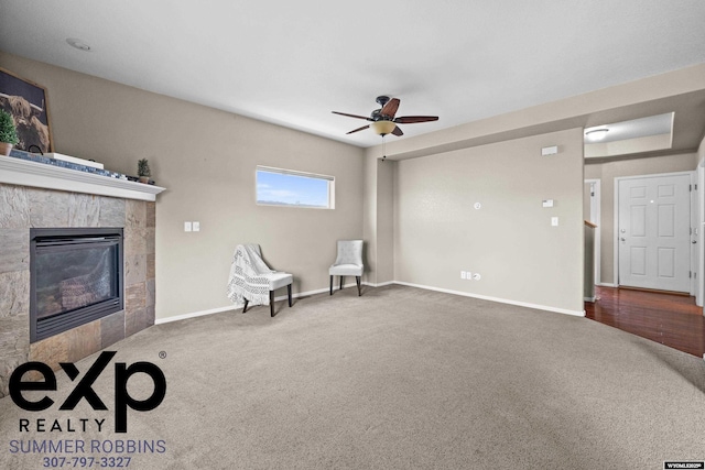 2521 Sagewood Ave, Casper, WY 82601 - unfurnished room featuring carpet, a tile fireplace, ceiling fan, and baseboards