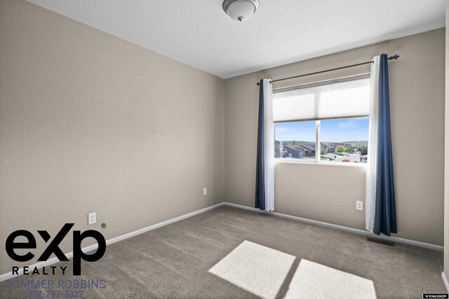 2521 Sagewood Ave, Casper, WY 82601 - spare room featuring carpet and baseboards