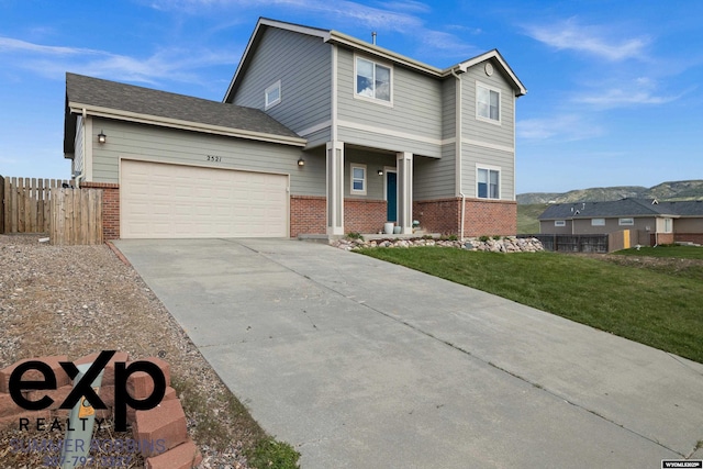 2521 Sagewood Ave, Casper, WY 82601 - traditional home with brick siding, an attached garage, and driveway