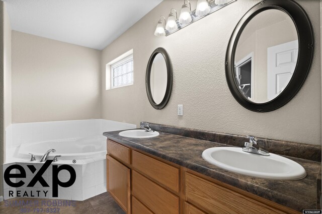 2521 Sagewood Ave, Casper, WY 82601 - bathroom with double vanity, a garden tub, and tile patterned floors