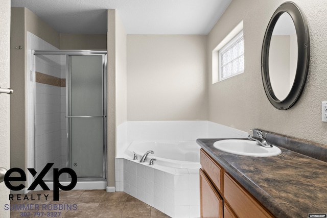 2521 Sagewood Ave, Casper, WY 82601 - bathroom featuring a shower stall, vanity, a bath, tile patterned flooring, and a textured wall