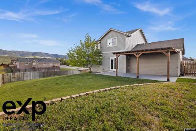 2521 Sagewood Ave, Casper, WY 82601 - rear view of property with a patio area, a mountain view, and roof with shingles
