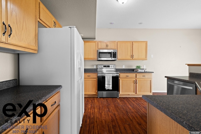 2521 Sagewood Ave, Casper, WY 82601 - kitchen with stainless steel appliances, light brown cabinetry, dark wood-style flooring, dark countertops, and baseboards