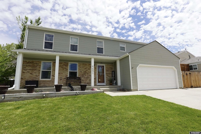 4451 S David St, Casper, WY 82601 - view of front of house featuring driveway, a garage, brick siding, and a porch