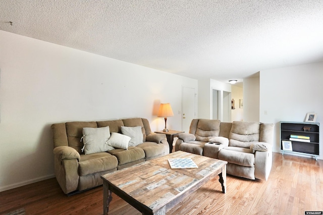 4451 S David St, Casper, WY 82601 - living room featuring light wood-style floors, a textured ceiling, and baseboards