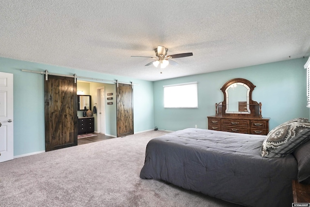 4451 S David St, Casper, WY 82601 - carpeted bedroom with a barn door, ceiling fan, a textured ceiling, and baseboards