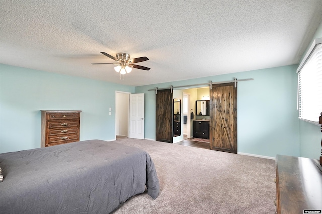 4451 S David St, Casper, WY 82601 - bedroom featuring a barn door, carpet, a textured ceiling, ceiling fan, and baseboards