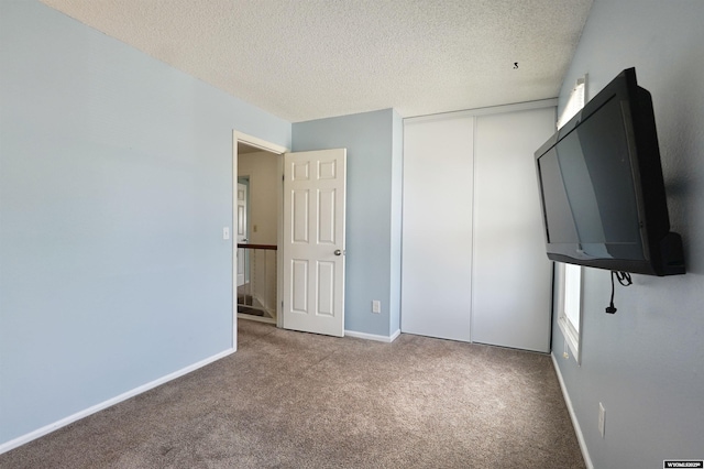4451 S David St, Casper, WY 82601 - unfurnished bedroom featuring carpet, a textured ceiling, a closet, and baseboards