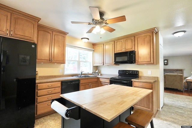4451 S David St, Casper, WY 82601 - kitchen with black appliances, a sink, ceiling fan, and light countertops