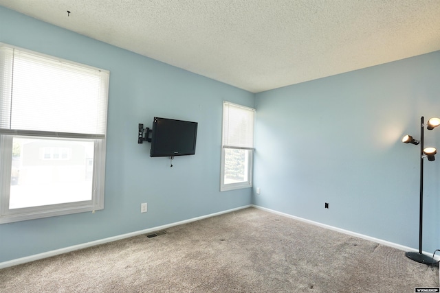 4451 S David St, Casper, WY 82601 - empty room featuring carpet flooring, a textured ceiling, and baseboards