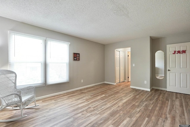 4451 S David St, Casper, WY 82601 - unfurnished room with light wood-style flooring, a textured ceiling, and baseboards