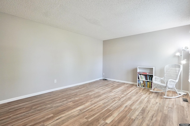 4451 S David St, Casper, WY 82601 - spare room with wood finished floors, baseboards, and a textured ceiling