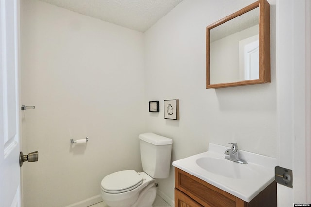 4451 S David St, Casper, WY 82601 - half bath with toilet, baseboards, vanity, a textured ceiling, and tile patterned floors