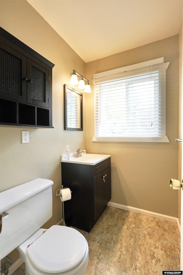 4451 S David St, Casper, WY 82601 - bathroom with vanity, toilet, and baseboards