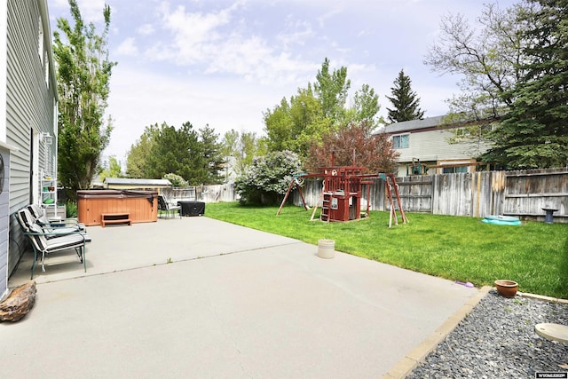 4451 S David St, Casper, WY 82601 - view of patio featuring a hot tub and a playground