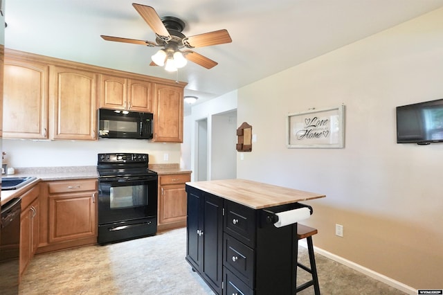4451 S David St, Casper, WY 82601 - kitchen featuring black appliances, a ceiling fan, a kitchen bar, and dark cabinets