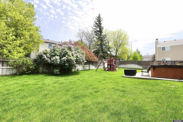 4451 S David St, Casper, WY 82601 - view of yard with a playground, a hot tub, and a patio