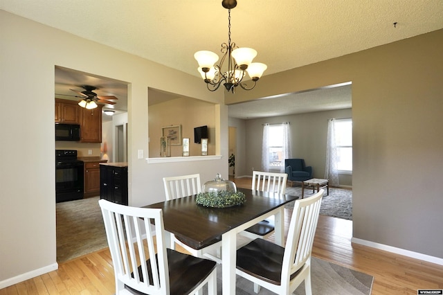 4451 S David St, Casper, WY 82601 - dining space with light wood-type flooring, a chandelier, baseboards, and ceiling fan