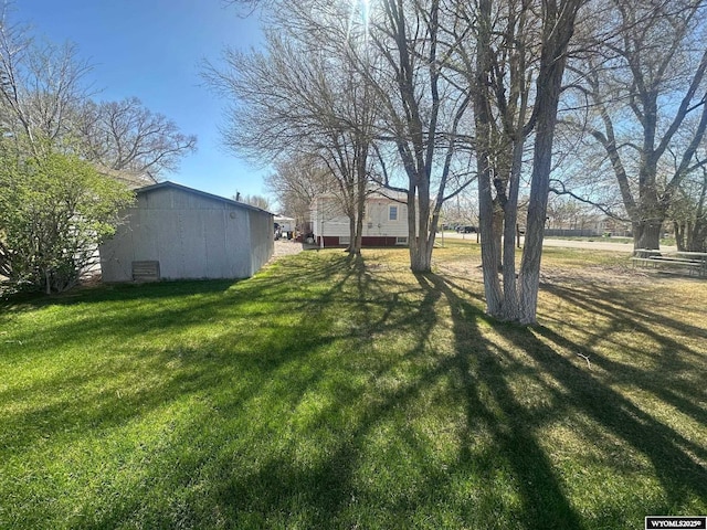 101 9th, Sinclair, WY 82334 - view of green lawn featuring an outbuilding