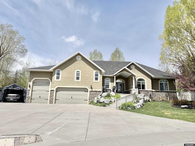 617 Lucille Cir, Evanston, WY 82930 - view of front of property with stucco siding, concrete driveway, stone siding, and a front lawn