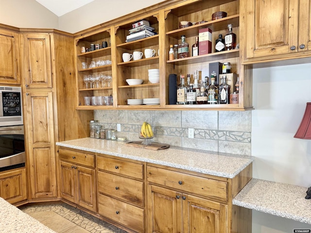 617 Lucille Cir, Evanston, WY 82930 - kitchen featuring oven, built in microwave, open shelves, and backsplash
