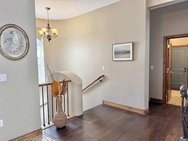 617 Lucille Cir, Evanston, WY 82930 - staircase featuring hardwood / wood-style flooring, a chandelier, and baseboards
