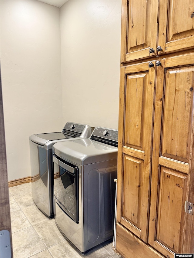 617 Lucille Cir, Evanston, WY 82930 - laundry room featuring cabinet space, washer and dryer, light tile patterned floors, and baseboards