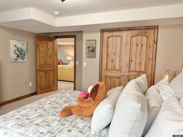 617 Lucille Cir, Evanston, WY 82930 - bedroom with light carpet, a textured ceiling, and baseboards
