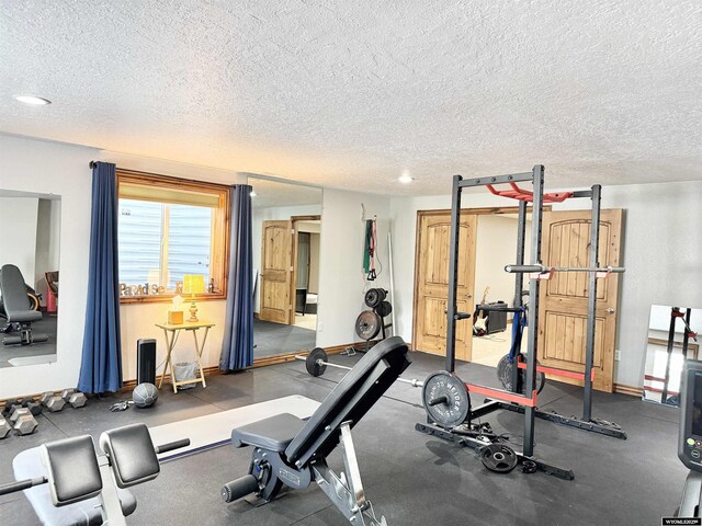 617 Lucille Cir, Evanston, WY 82930 - workout area with a textured ceiling and baseboards