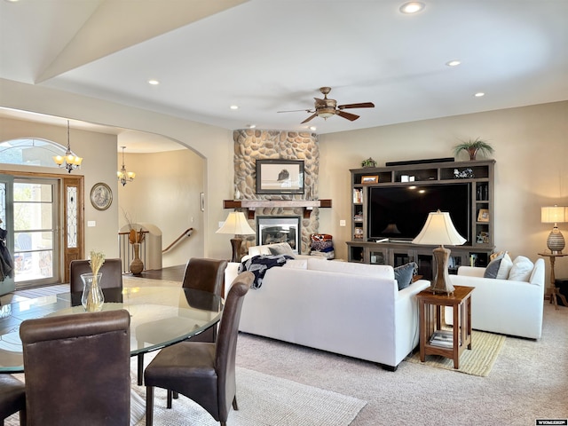 617 Lucille Cir, Evanston, WY 82930 - carpeted living area featuring a ceiling fan, recessed lighting, a fireplace, arched walkways, and a chandelier