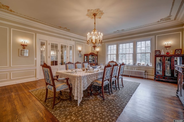 1108 S Wolcott St, Casper, WY 82601 - dining room featuring a decorative wall, radiator heating unit, french doors, ornamental molding, and a chandelier