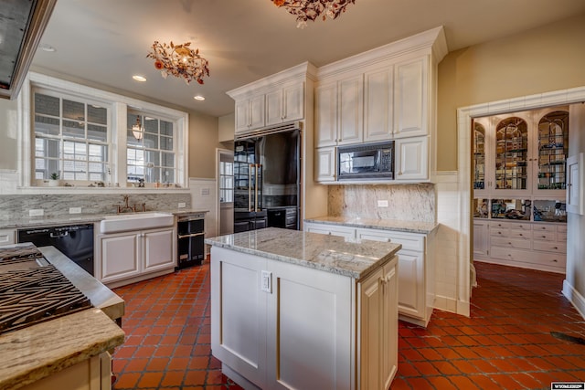 1108 S Wolcott St, Casper, WY 82601 - kitchen with black appliances, a sink, recessed lighting, decorative backsplash, and white cabinetry