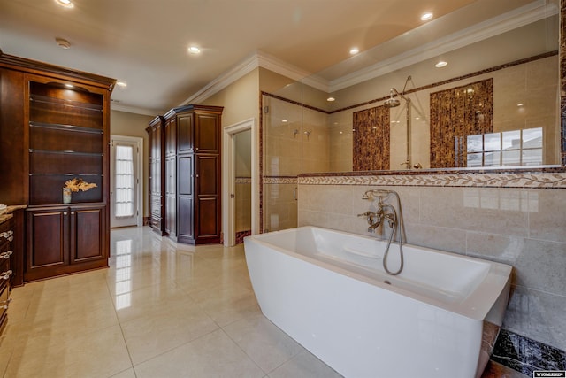 1108 S Wolcott St, Casper, WY 82601 - bathroom with crown molding, a freestanding bath, tile walls, tile patterned flooring, and recessed lighting