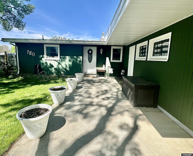 720 S 16th St, Worland, WY 82401 - property entrance featuring a lawn and a patio