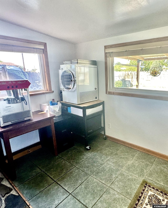 720 S 16th St, Worland, WY 82401 - bathroom with plenty of natural light, baseboards, and stacked washer and clothes dryer