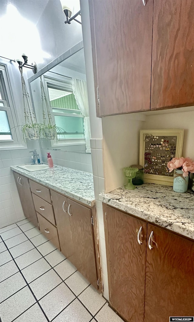 720 S 16th St, Worland, WY 82401 - bathroom featuring a sink, tile patterned flooring, and tile walls