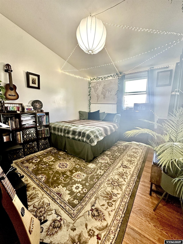 720 S 16th St, Worland, WY 82401 - bedroom featuring lofted ceiling and wood finished floors