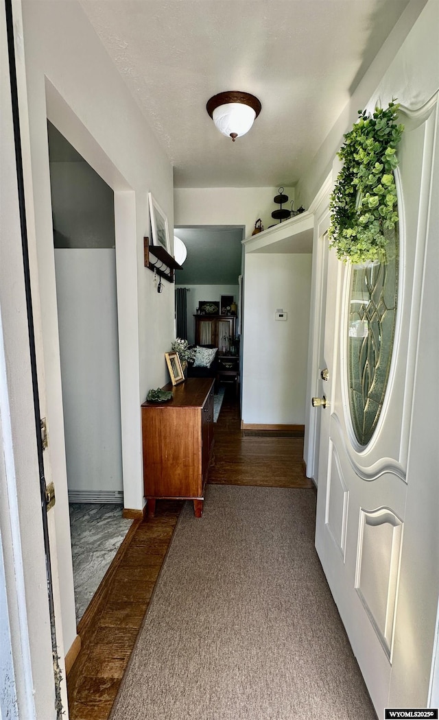 720 S 16th St, Worland, WY 82401 - entrance foyer with baseboards and dark colored carpet