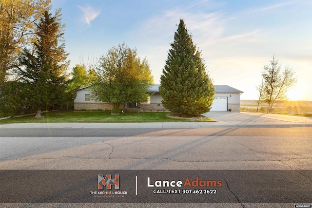 396 Williams Way, Glenrock, WY 82637 - view of front facade featuring concrete driveway, a front lawn, and an attached garage