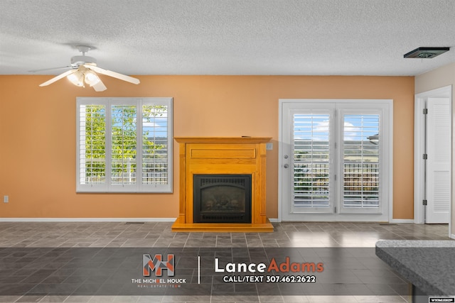 396 Williams Way, Glenrock, WY 82637 - tiled living area with a textured ceiling, a fireplace with raised hearth, ceiling fan, and baseboards